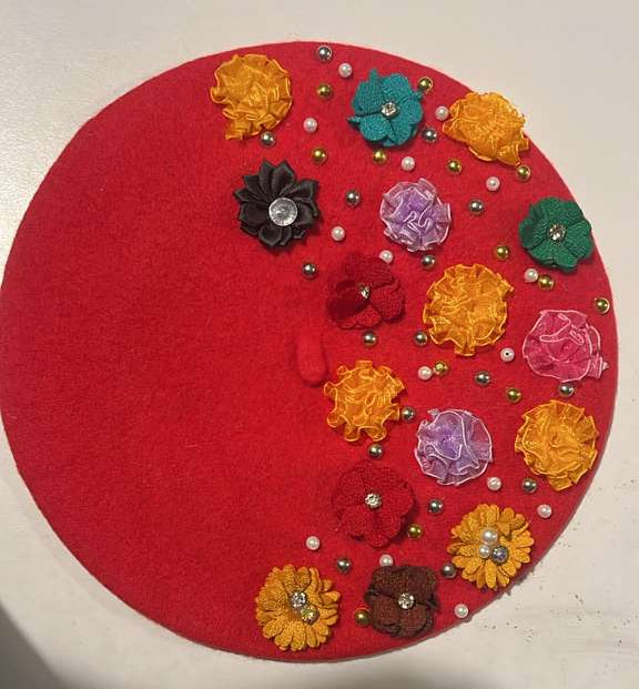 Red felt beret decorated with multicolor fabric flowers and pearl beads