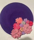 Deep purple felt beret decorated with pink, coral and lavender fabric flowers
