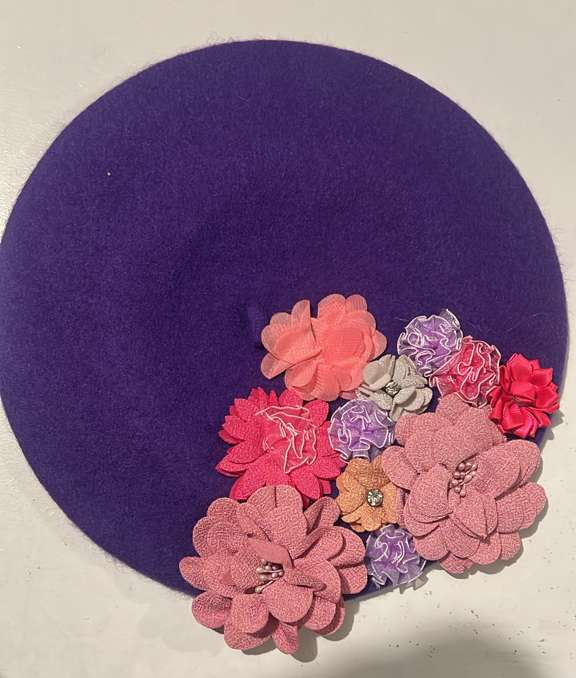 Deep purple felt beret decorated with pink, coral and lavender fabric flowers