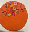 Orange felt beret decorated with multicolor fabric flowers and pearl accents