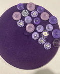 Deep purple felt beret decorated with assorted purple buttons