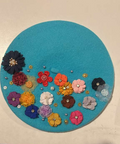 Turquoise felt beret decorated with over 15 multicolor fabric flowers with rhinestone and gold accents