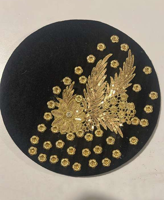 Black felt beret with gold lace floral appliqué and scattered gold sunflower charm studs