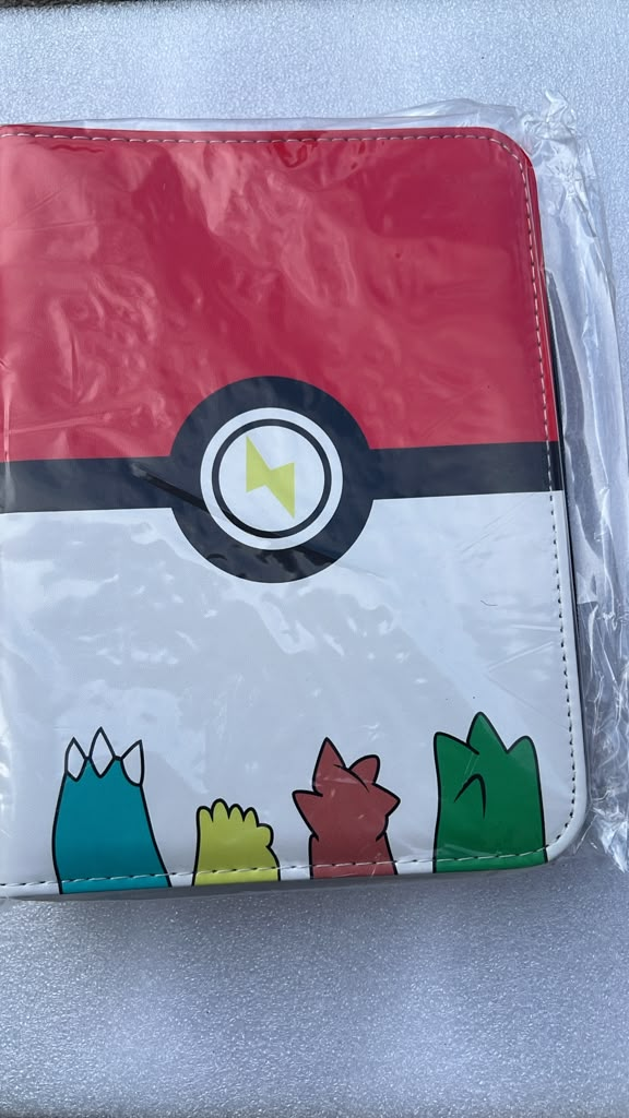 Poké Ball starter heads 4-ring binder red and white with colorful starter Pokémon peeking at bottom