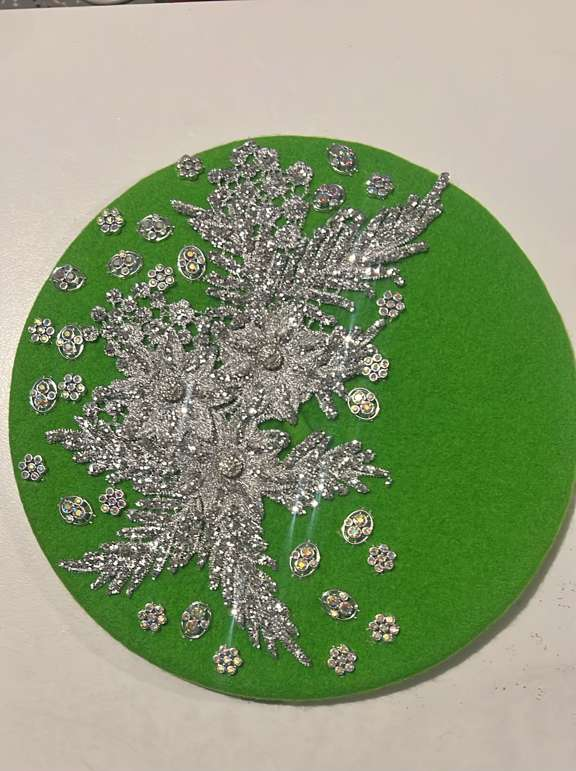Bright green felt beret with silver lace floral appliqué and scattered rhinestone flower charms