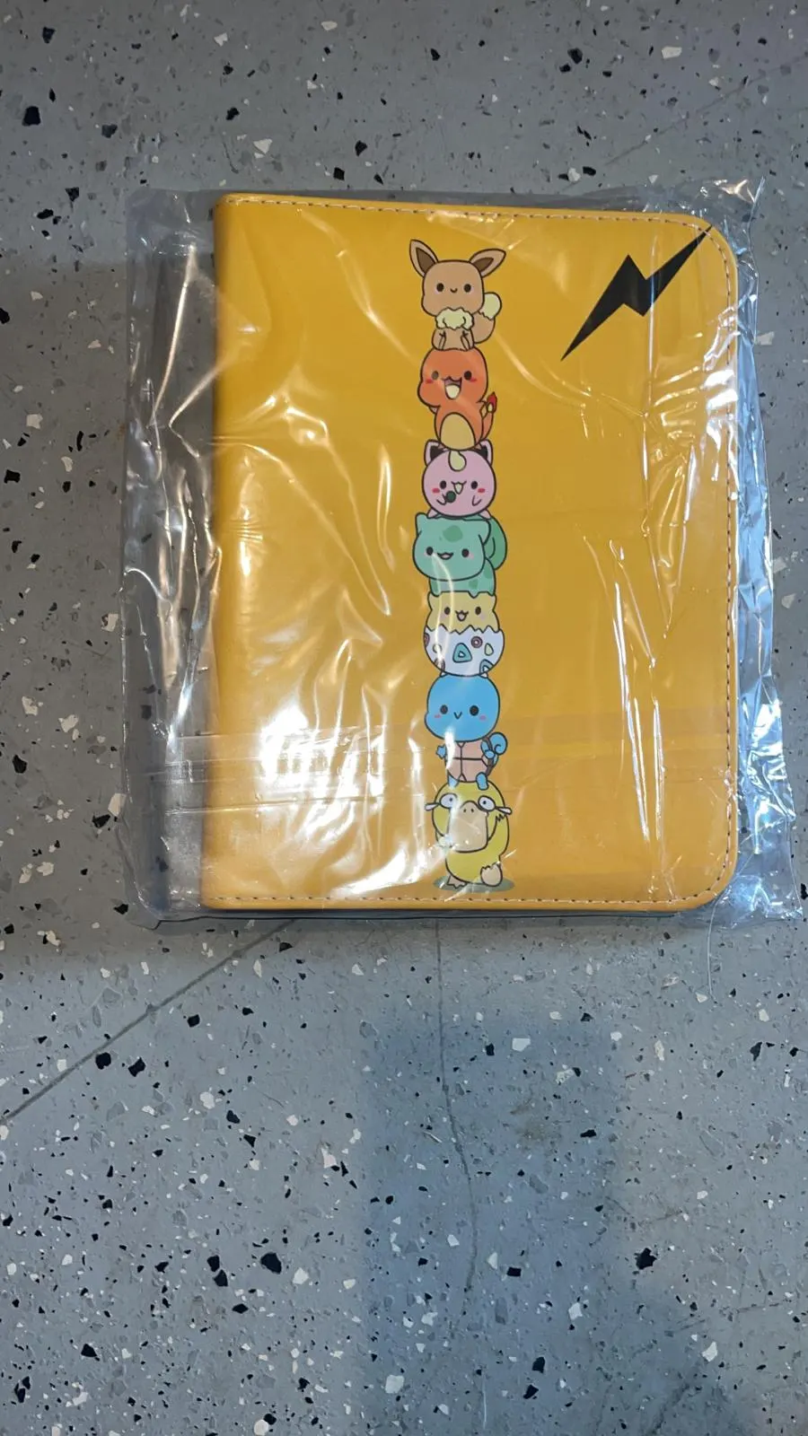 Pokémon 4-ring binder yellow cover with stacked Pokémon characters